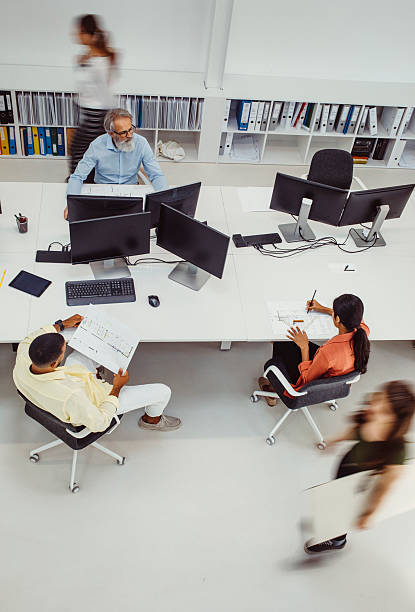 istock Focused Employees Engaging in Architectural Planning at Modern Biro 2244929333