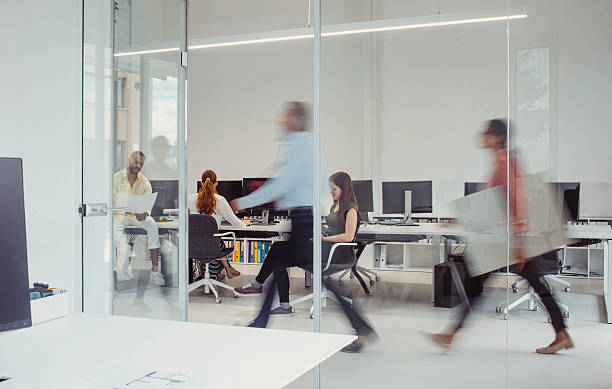 istock Professionals Engaging in Collaborative Tasks in a Busy Office Environment 2244929346