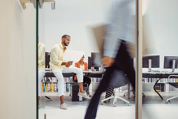 Two business women work in the office to solve problems and sign agreements.