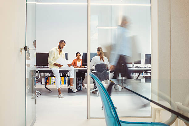 istock Mid Adult Multiracial Architect Engaging with Colleagues in Modern Office 2244929352