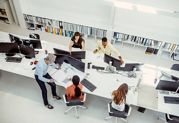 istock Team of Diverse Professionals Collaborating on Design Plans in Office 2244929395