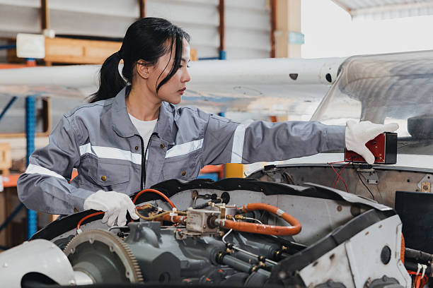 istock Woman working on aircraft engine in hangar during day, checking electrical systems and ensuring safety 2244930684