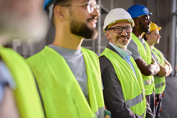 istock Happy male civil engineer among manual workers at construction site. 2244930697