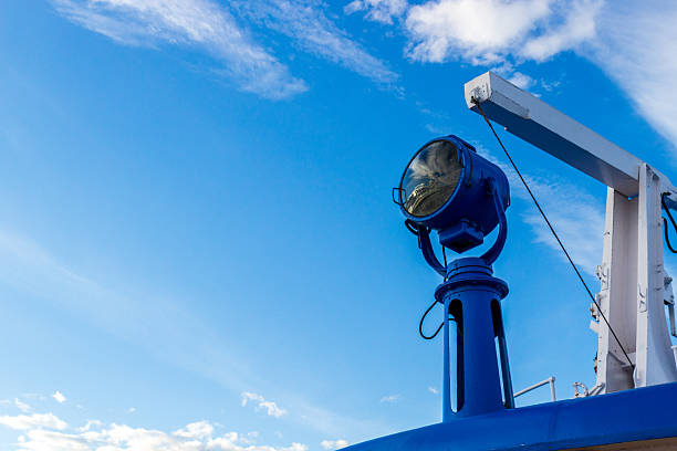 A riverboats searchlight against a blue sky with copy space