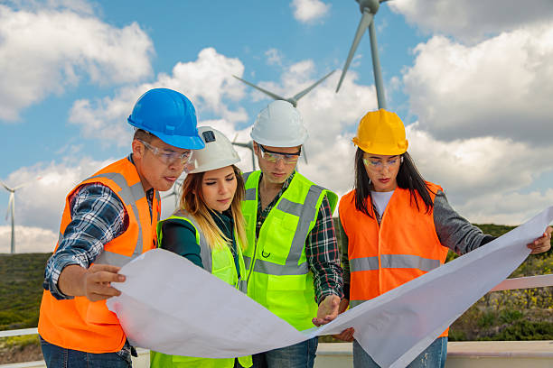 istock Engineers and Architects Analyzing Blueprints and Communicating at a Wind Farm for Renewable Energy and Sustainability Projects 2244933661