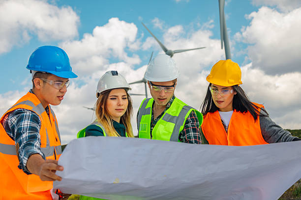 istock Engineers and Architects Analyzing Blueprints and Communicating at a Wind Farm for Renewable Energy and Sustainability Projects 2244933666