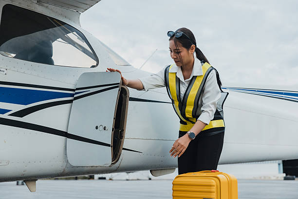 istock Aviation professional checking aircraft hatch while preparing for flight at the airport 2244933754