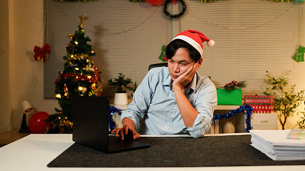 istock Businessman working late on Christmas day in office 2244934607