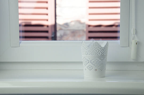 istock White decorative pot on window sill — minimalist interior accent 2244934618