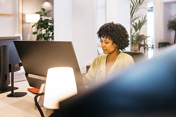 istock Black woman working at modern office desk 2244935863