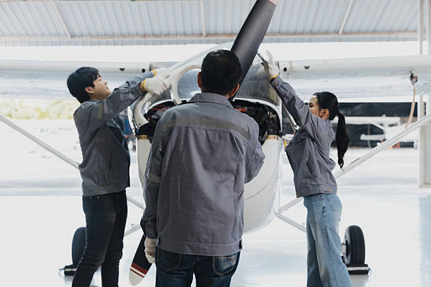 istock Three students work together to repair an airplane in a hangar during a training session 2244936005