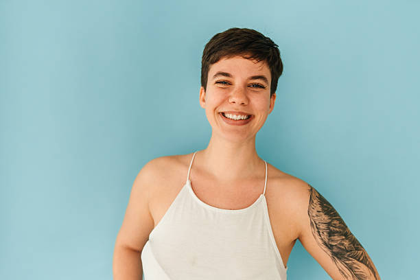 istock Happy Young Woman with Tattoo in Studio 2244936442