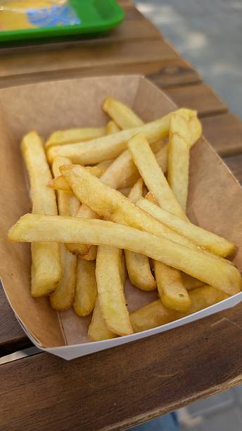 istock Salty crispy snacks on tray, Vivid midday snack with crispy fries 2244936521