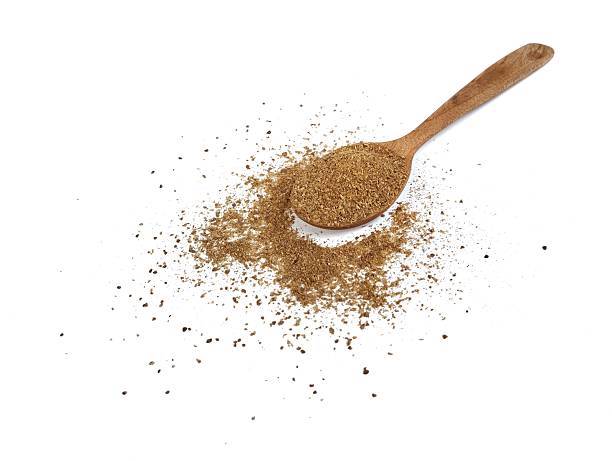 istock Coriander powder on wooden spoon isolated on white background 2244936915