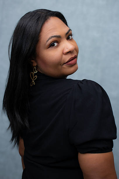 istock Beautiful plus size brown-skinned woman looking over her shoulder. 2244937069