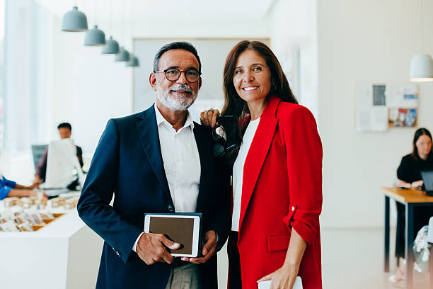 istock Confident senior professionals in an office setting posing together with smiles 2244938350