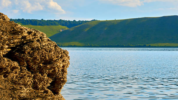 a large natural stream of water flowing in a channel to the sea, a lake, or another such stream.