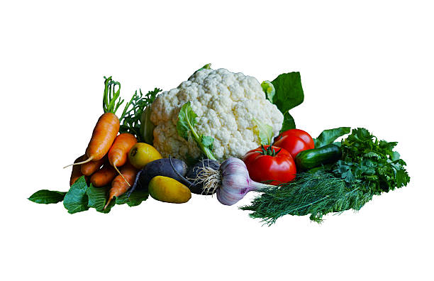 There are vegetables and greens on a white background