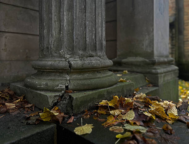 Weathered architecture detail of ancient pillar with moss and decay, symbol of time and impermanence.