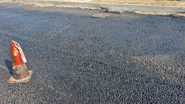 istock New road surface, Freshly laid roadway with safety cones present 2244939394