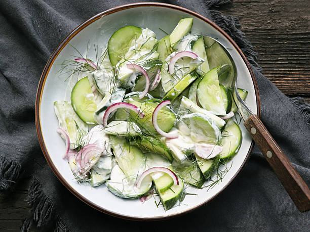 istock Cucumber with red onion and dill salad in yogurt dressing 2244939775
