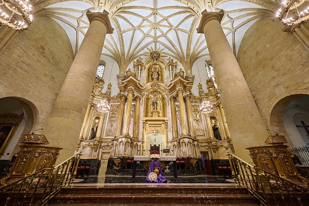 Gold baroque altarpiece and vaulted ceiling in a historic european church interior, showcasing religious architecture