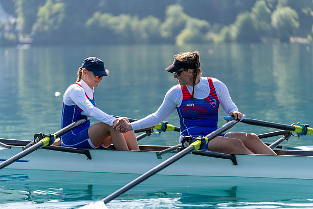 istock Supportive Female Rowers Sharing Encouragement During Training on Serene Lake Bled 2244942998