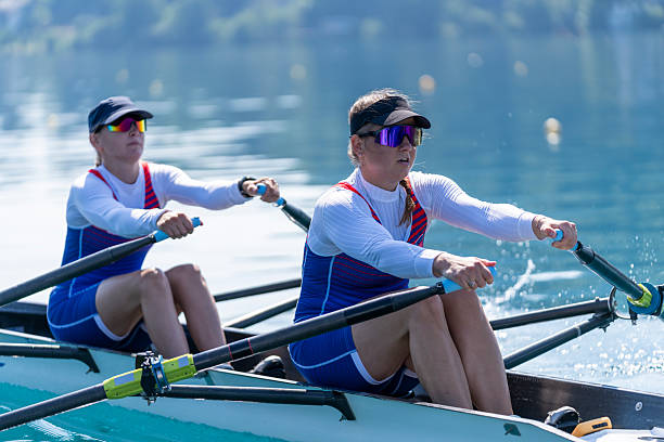 istock Focused Female Athletes Rowing on Serene Lake Bled During Intense Training Session 2244943032