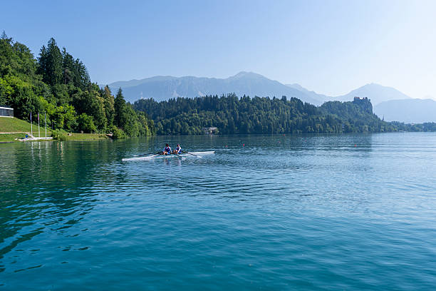 istock Focused Female Rowing Duo Training on Scenic Lake Bled in Double Scull Shell 2244943040