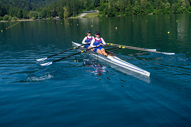istock Determined Young Caucasian Female Athletes Rowing Double Scull on Lake Bled During Practice 2244943062