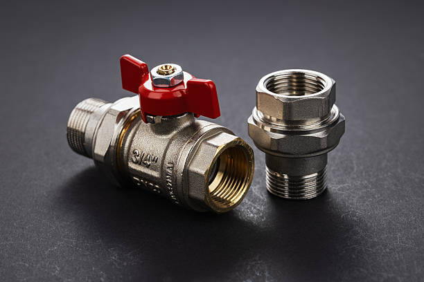 water ball valve with connecting fitting, on dark background. Threaded connection American.