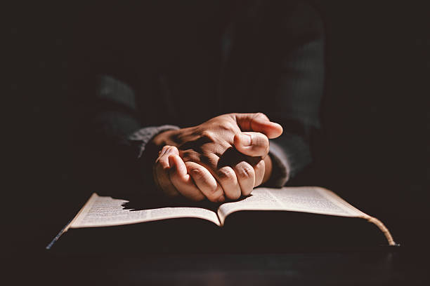 istock Hands folded in prayer on the Holy Bible, symbolizing faith, devotion, Christianity, hope, and spiritual strength. Concept of worship, meditation and trusting God Word. 2244945907