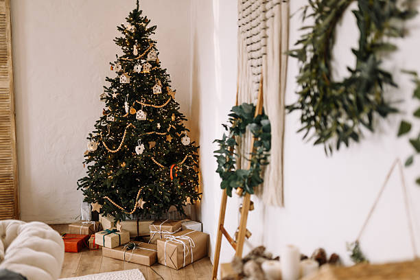 istock Stylish Christmas tree with presents in Scandinavian interior 2244946466