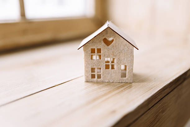 istock Miniature house decoration on wooden table 2244946494