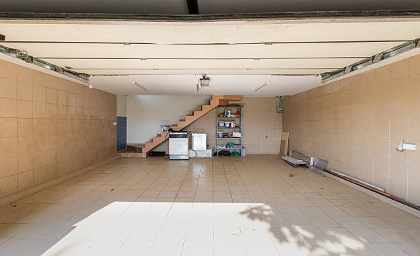istock Empty Garage with Open Door and Staircase Leading to Storage 2244947363