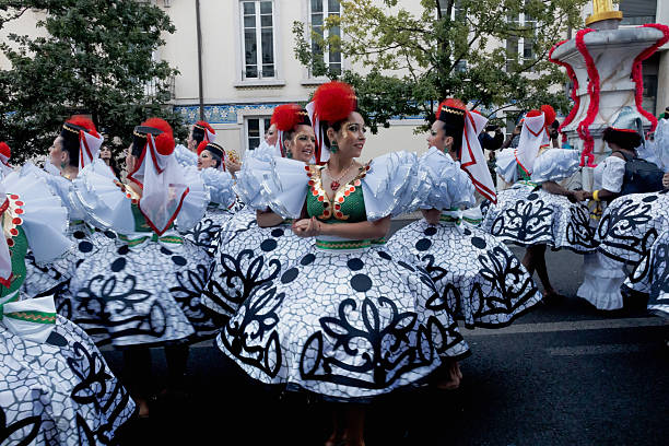 Lisbon, Porugal - June 12, 2024: Women dressed in traditional folklore costumes, parade in Lisbon downtown during this city celebrations of the Popular Saints.