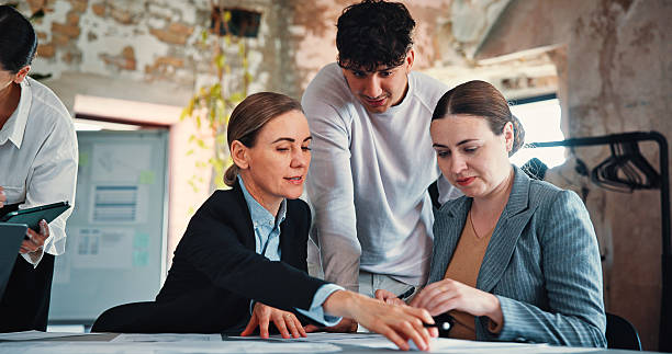 istock Marketing, review or people with paperwork in creative agency, content release schedule or agenda. Planning, teamwork and employees with branding discussion, coworking and promotion campaign calendar 2244948336