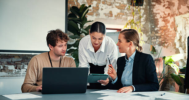 istock Laptop, tablet or marketing team with paperwork in creative agency, content release schedule or agenda. Review, collaboration or people talk with tech, brand discussion or promotion campaign calendar 2244948363