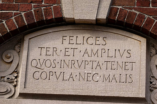 istock Latin Inscription on Antique Stone Plaque Mounted on Archway 2244948696