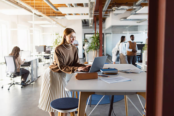 istock Young Stylish Businesswoman Working on Laptop in Bright Open-Plan Workspace 2244948869