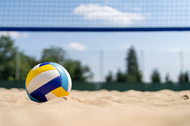 istock Vibrant Volleyball on Sandy Beach Court Under Clear Blue Sky 2244950253