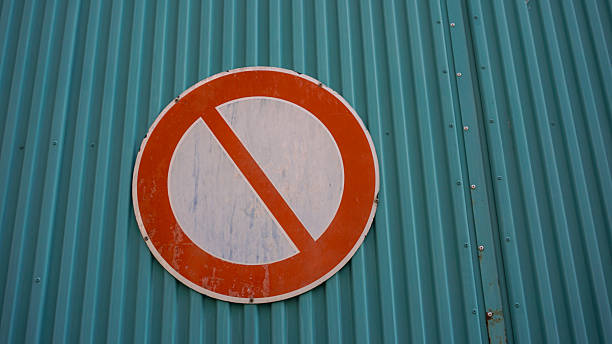 istock Weathered No entry sign mounted on teal corrugated metal wall 2244954709