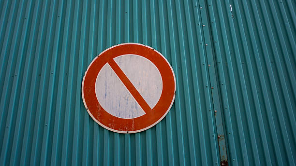 istock Weathered No entry sign mounted on teal corrugated metal wall 2244954906