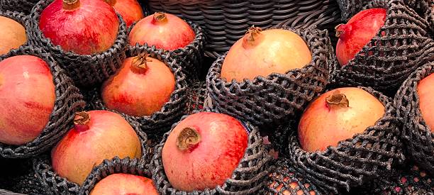 istock Red pomegranates in a fruit shop 2244955238