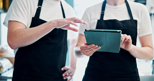 istock Chef, team and hands with tablet, restaurant and menu planning with research, online and hospitality. Searching, info and people with tech for recipe, scroll or collaboration for meal prep in kitchen 2244955488