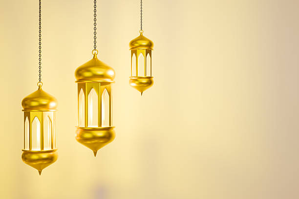 A glowing lantern and stars are hanging to celebrate Eid Mubarak.