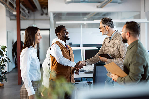 istock Handshake Between Two Team Members During a Meeting in a Contemporary Open-Plan Office 2244960326