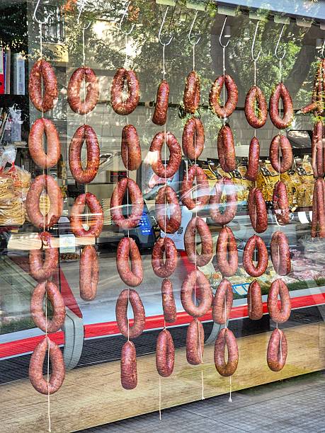 Traditional homemade sausage, hung in round rings in vertical rows on an open counter