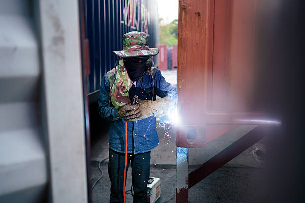 Do-it-yourself - a man does metal welding using an electric device