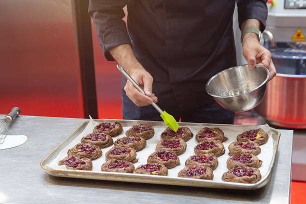 Confectioner makes delicious cookies on a pastry shop tray